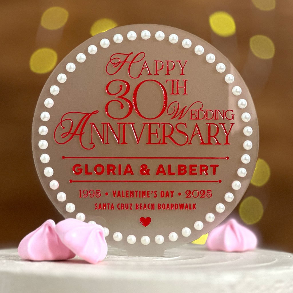 Personalized anniversary cake toppers with a pearl border, custom names, and a snap-off stake for easy display